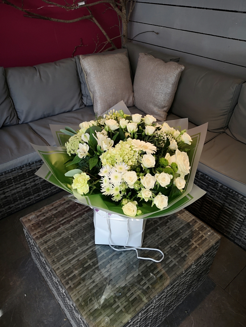 handtied flower bouquet gift wrapped in an a bubble of water or gift bag for monthly subcription service