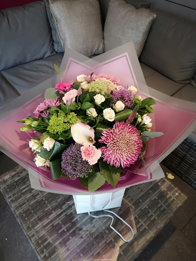 handtied flower bouquet gift wrapped in an a bubble of water or gift bag for monthly subcription service