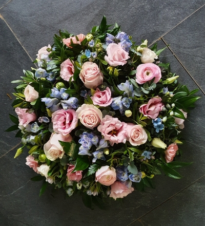 A delicate posy of pastel pink roses and baby blue delphinium with a combination of dainty complimenting blooms.
