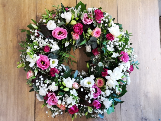 Pink and white flower and foliage funeral tribute wreath 