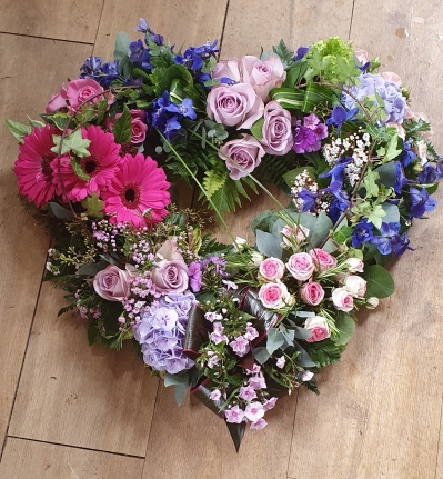 textured pink and purple flower and foliage open heart funeral tribute 