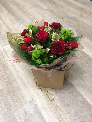Festive red and green christmas flower bouquet gift bag