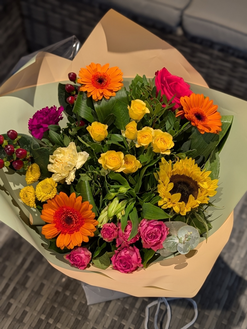 Rich and vibrant autumnal flowers in a gift bag