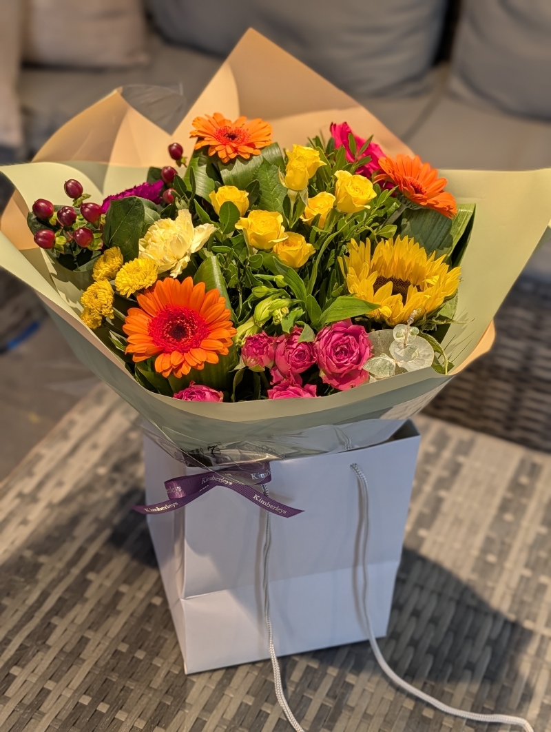 Rich and vibrant autumnal flowers in a gift bag