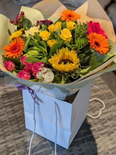 Rich and vibrant autumnal flowers in a gift bag
