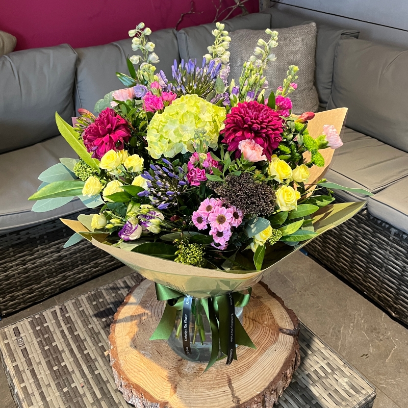 large wild style flower handtied bouquet in a vase