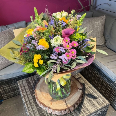 large wild style flower handtied bouquet in a vase