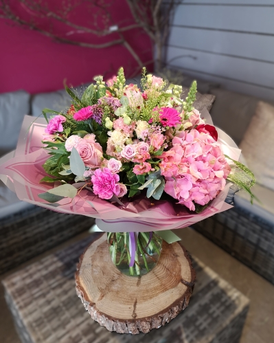 handtied flower bouquet gift wrapped in an a bubble of water or gift bag 