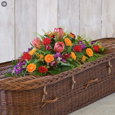 Bright and tropical flower and foliage coffin spray