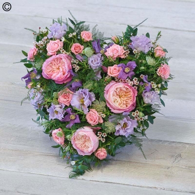 cottage style flower and foliage heart shaped funeral tribute