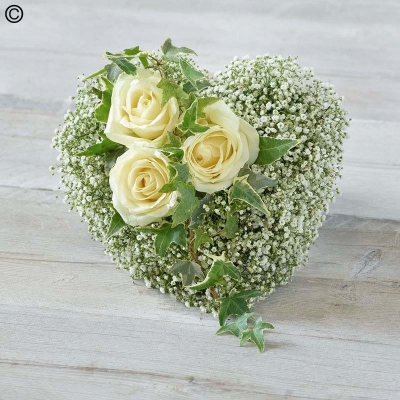 white rose and gypsophila heart shaped funeral tribute