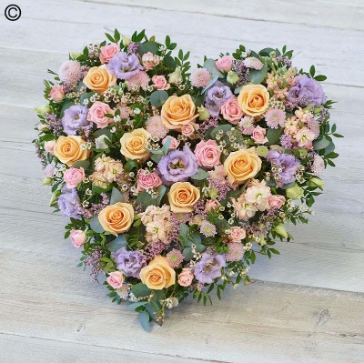pastel flower and foliage heart shaped funeral tribute