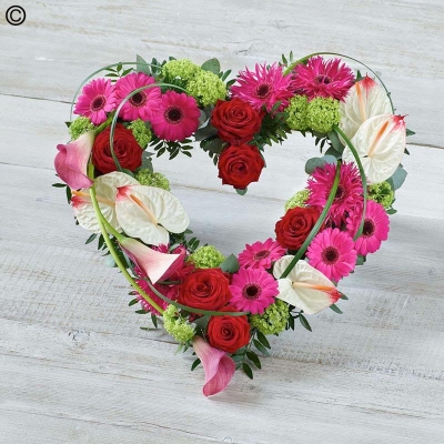 Contemporary flower and foliage open heart funeral tribute