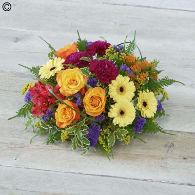 bold mixed flower and foliage funeral posy