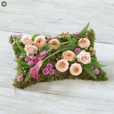 woodland style flower and moss covered pillow funeral tribute