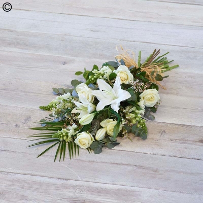 white and green flower and foliage funeral sheaf