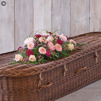 pastel mixed flower and foliage singled ended funeral coffin spray