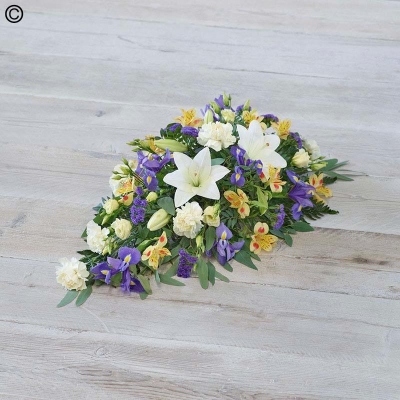 lemon and blue mixed flower and foliage single ended funeral coffin spray