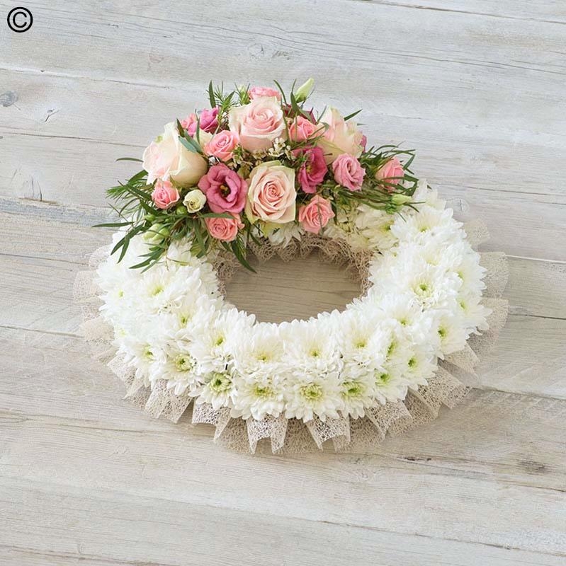 traditional white based flower funeral tribute wreath