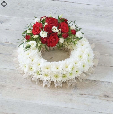 traditional white based flower funeral tribute wreath