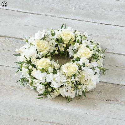 white flower and foliage funeral tribute wreath