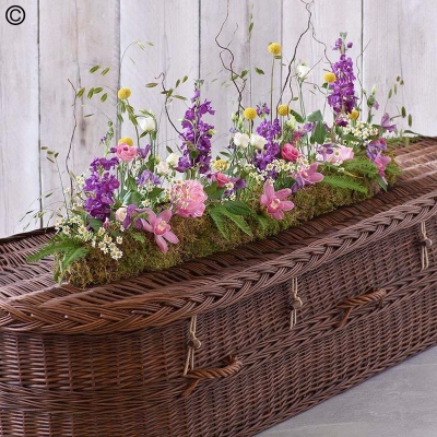 wild linear flower and foliage funeral coffin spray