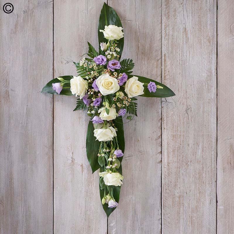 lilac and white flower and foliage cross funeral tribute