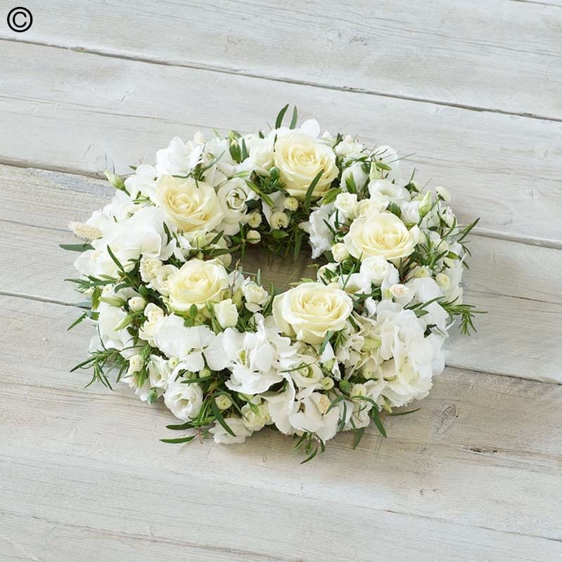 white flower and foliage funeral tribute wreath