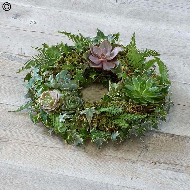 eco-friendly mossed funeral tribute with succulent plants