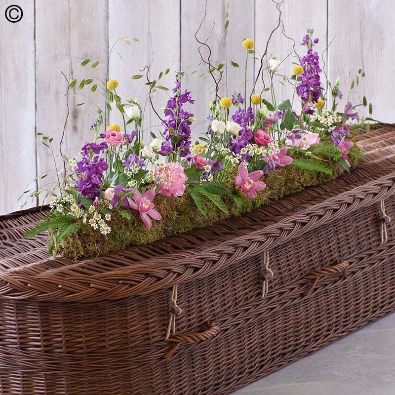 wild linear flower and foliage funeral coffin spray