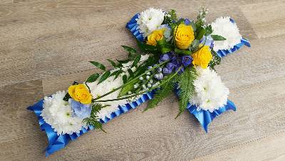 Blue, yellow and white based chrysanthemum cross funeral flower tribute 