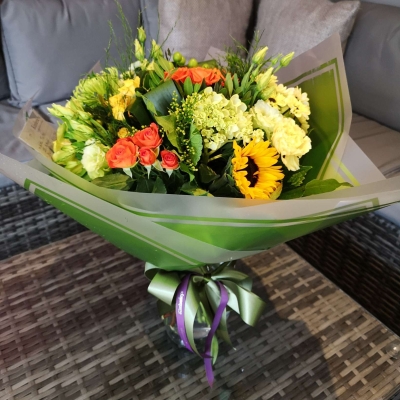 handtied flower bouquet gift wrapped in an a bubble of water or gift bag 