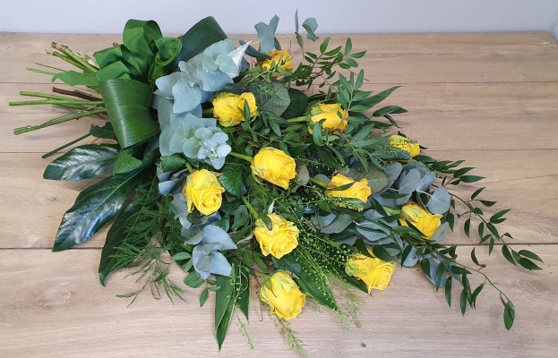 A beautiful sheaf of 12 premium bright yellow roses with an abundance of gorgeous foliage.