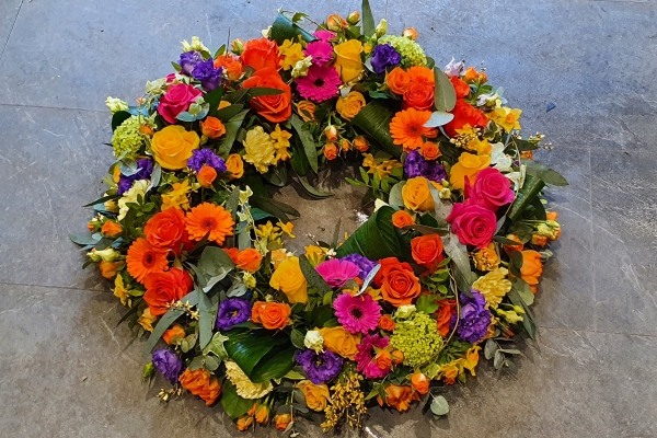 A bright carnival mix of flowers including oranges, yellows and lime greens.