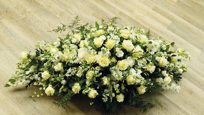 White and ivory flower and foliage double ended funeral coffin spray including roses and delphinium 