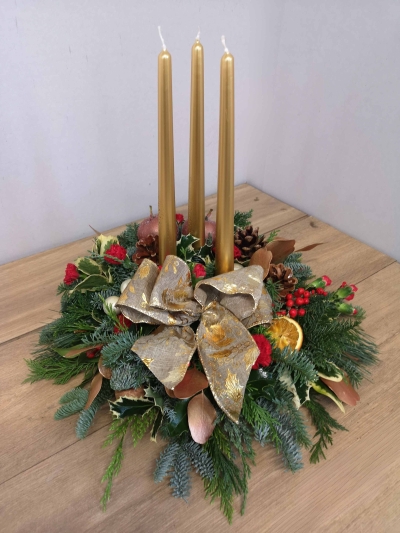 festive foliage candle table centre piece with gold bow