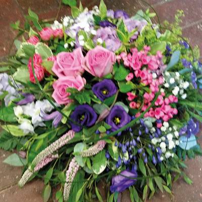 Grouped modern pink and purple flower and foliage posy funeral tribute