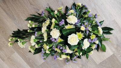 Lemon yellow and lilac single ended flower and foliage funeral coffin spray