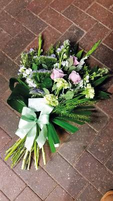 Pastel pink and lilac flower and foliage funeral tribute sheaf 