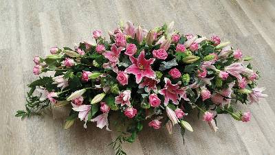 Pink rose and lily mixed foliage and flower double ended funeral coffin spray 