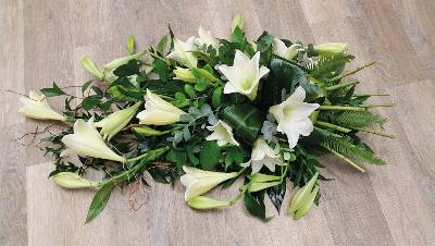 White flower and foliage single ended funeral coffin spray with lilies 