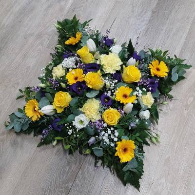 Yellow and purple loose cushion funeral flower tribute with ribbon 