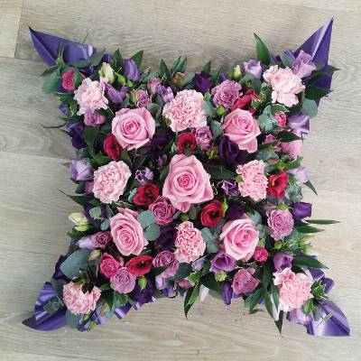 Pink and purple loose cushion funeral flower tribute with ribbon 