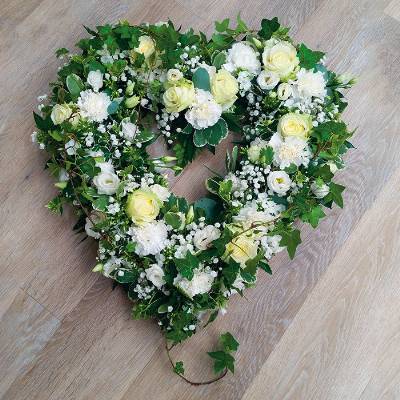 Loose white and ivory flower and foliage open heart funeral tribute 