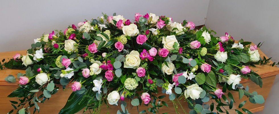 Loving Memories Double Ended Coffin Spray - a mix of white roses, pink roses, pink ranunculus, white freesias, and lush greenery