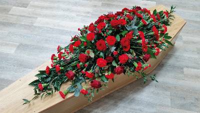 red rose, scarlett carnation and germini flower and foliage double ended funeral coffin spray