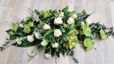 Modern flower and foliage double ended funeral coffin spray with orchids, anthuriums and roses