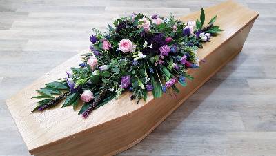 pastel pink, lilac and purple flower and foliage double ended funeral coffin spray with eucalyptus 