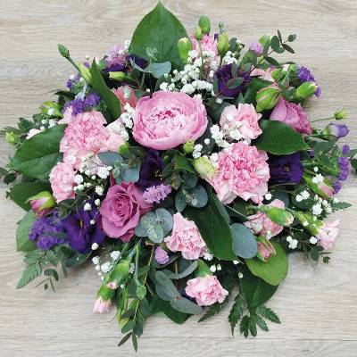 Pink and purple funeral tribute flower and foliage posy