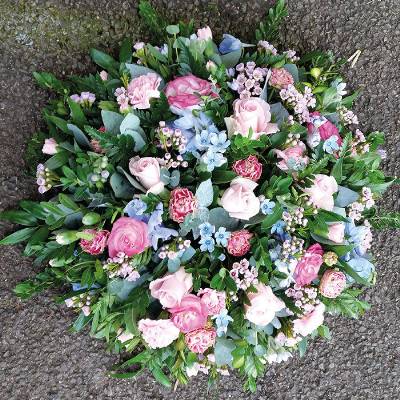 Baby blue and pastel pink flower and foliage posy funeral tribute